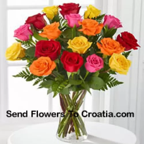 19支混合颜色的玫瑰，配以季节性的装饰，放在玻璃花瓶中
